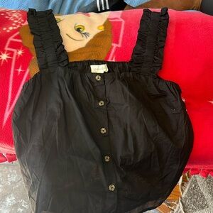 Black summer top over the shoulder straps.